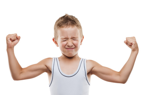 Beauty smiling sport child boy showing his hand biceps muscles strength white isolated