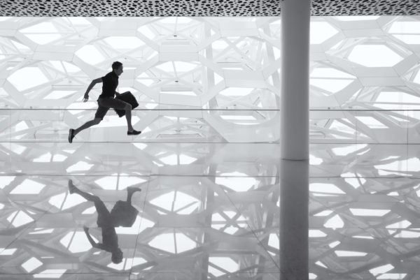 Andy runs through Shenzhen Airport with check-in luggage.